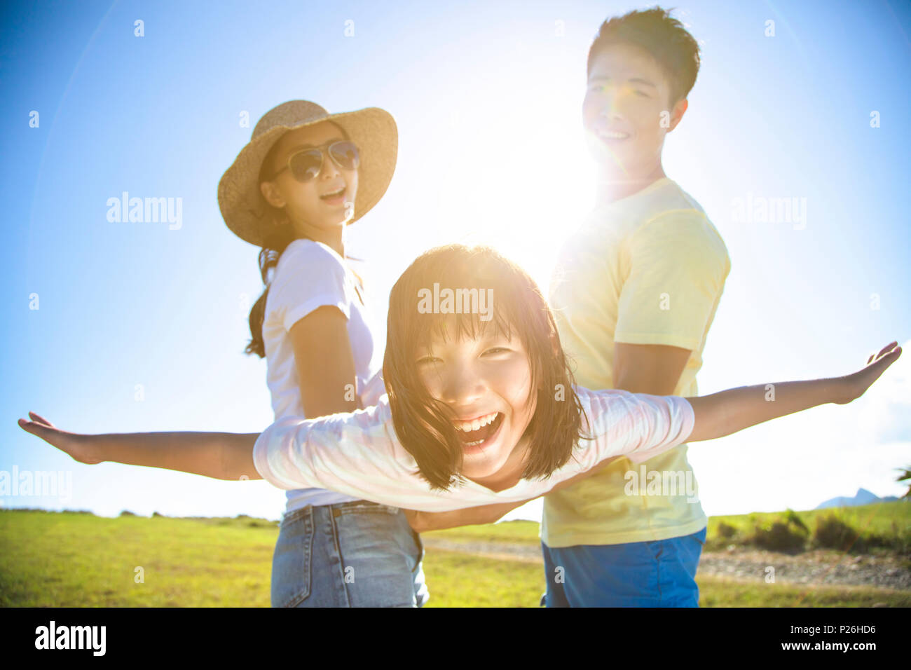 happy family playing on the grass Stock Photo