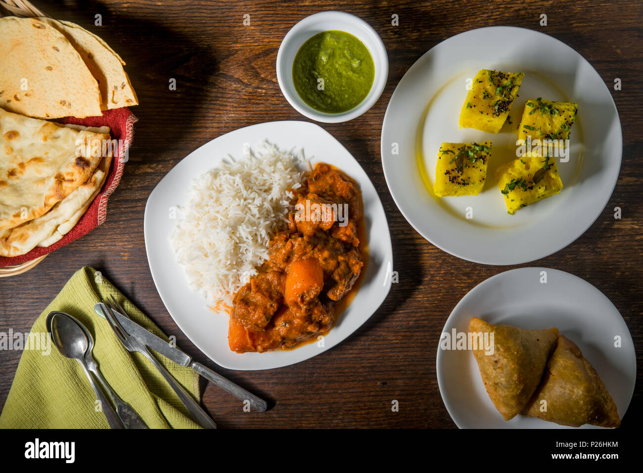 Indian lamb vindaloo dinner with several appetizers and naan bread