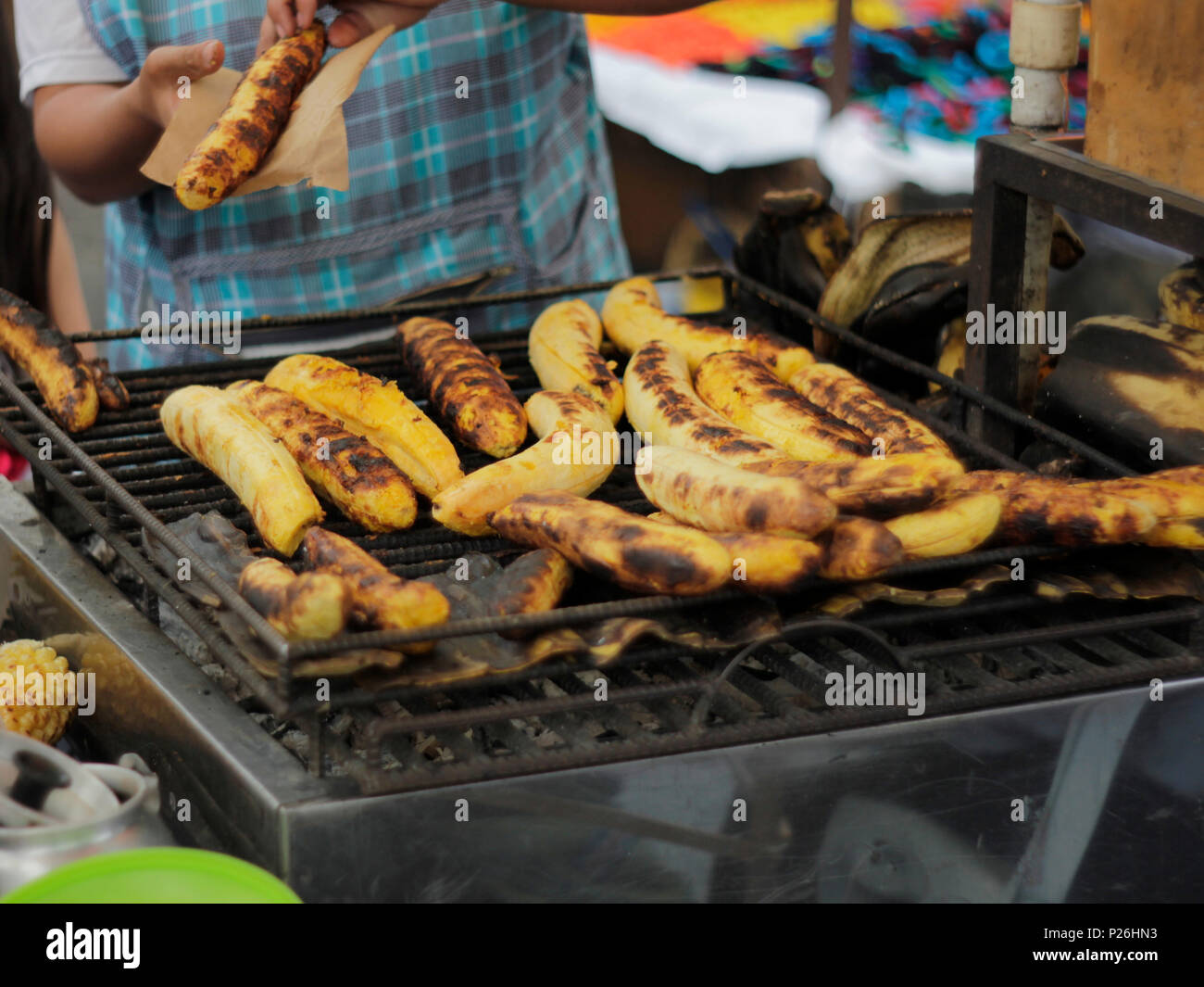 Bananas are grilled in a traditional market on the streets of Otavallo