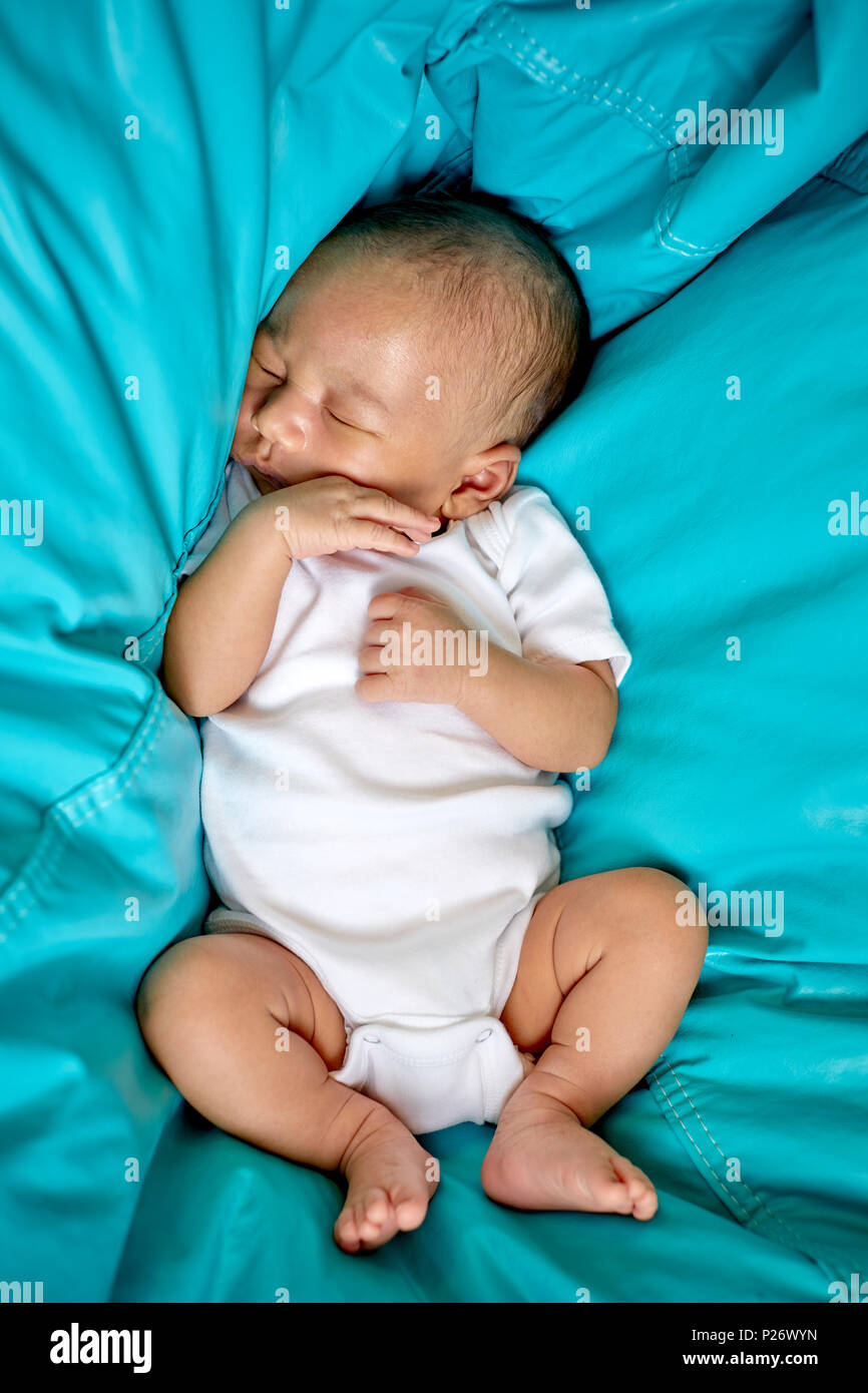 Baby Boy sleeping in a Teal blue bean bag chair Stock Photo Alamy