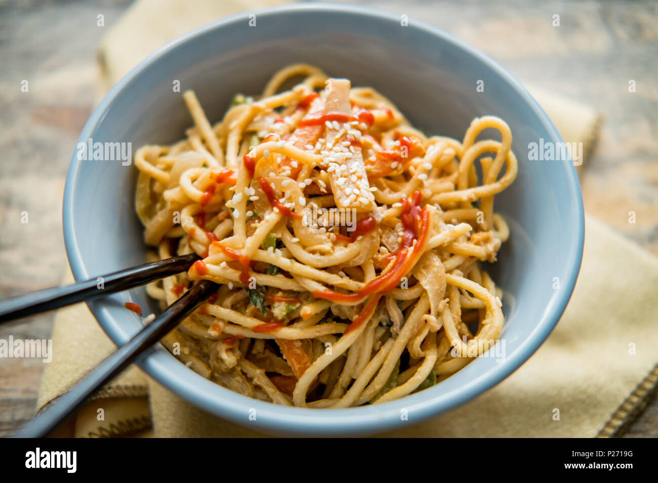 Spicy Thai vegetable peanut butter lo mein noodles with sesame seeds