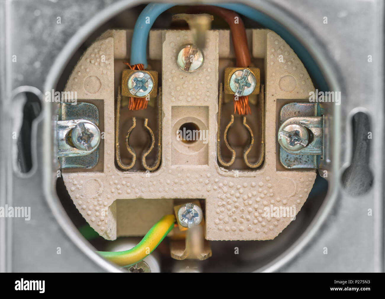 Electrical socket without cover. Closeup of wall socket with grounding