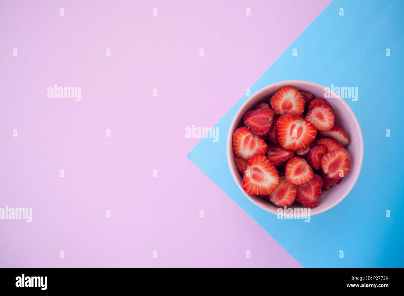 A pink bowl full of beautiful fresh juicy strawberries on pastel pink ...