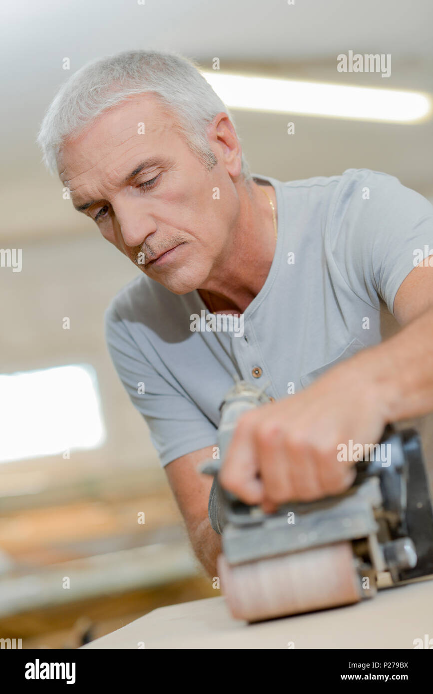 Carpenter using a belt sander Stock Photo Alamy