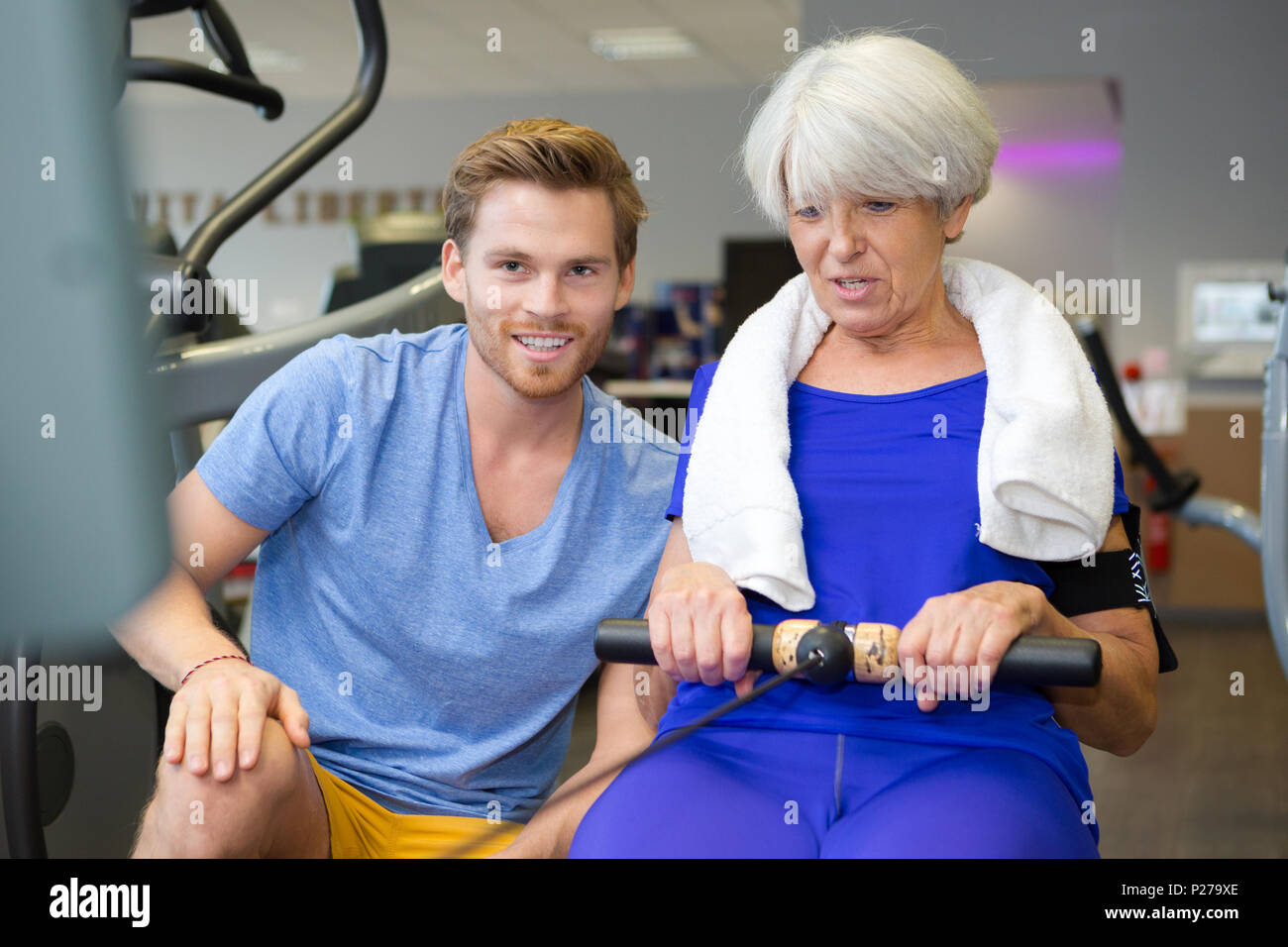 pretty woman using rowing machine Stock Photo - Alamy