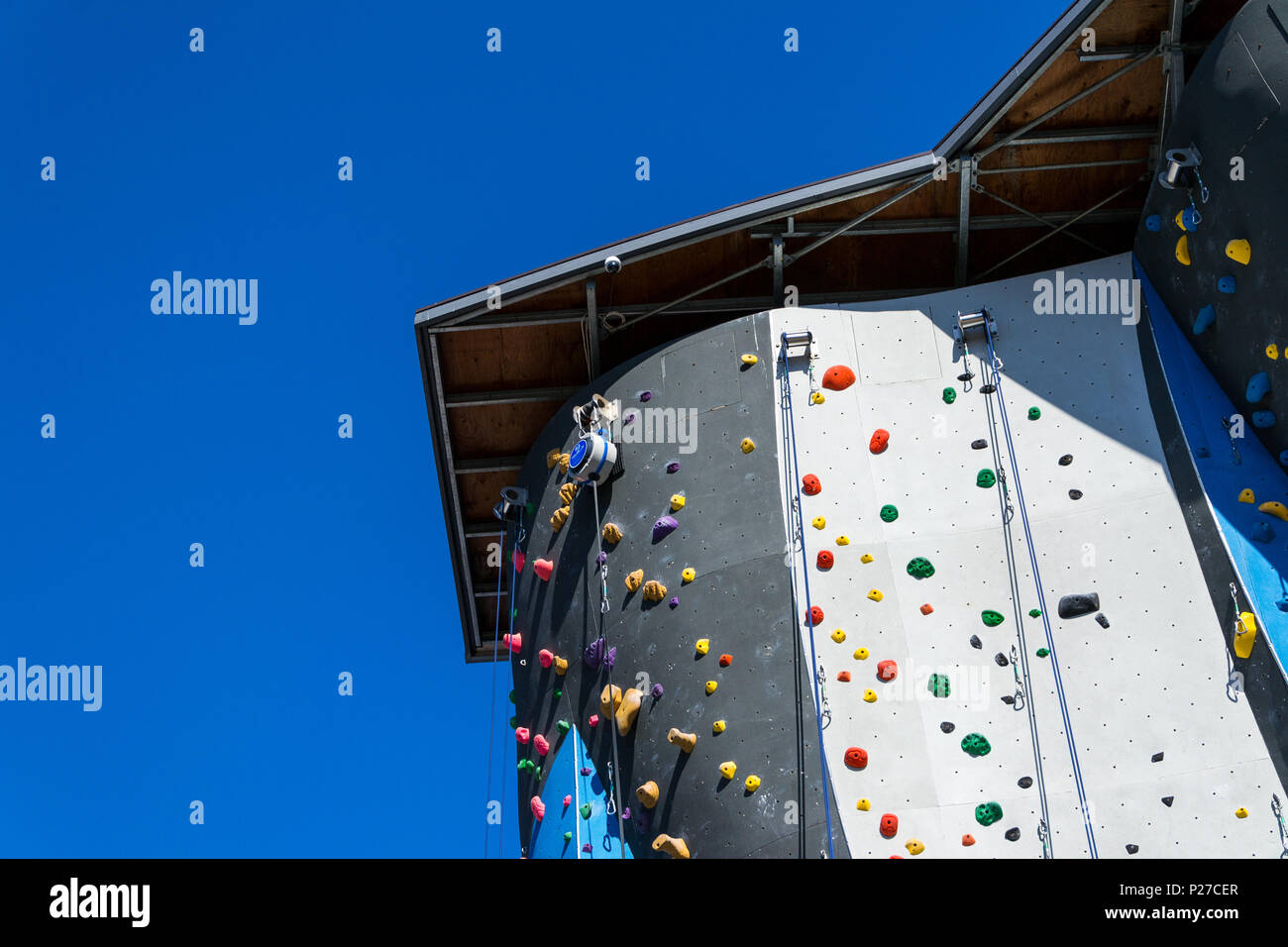 Blue and black artificial rock climbing wall Stock Photo