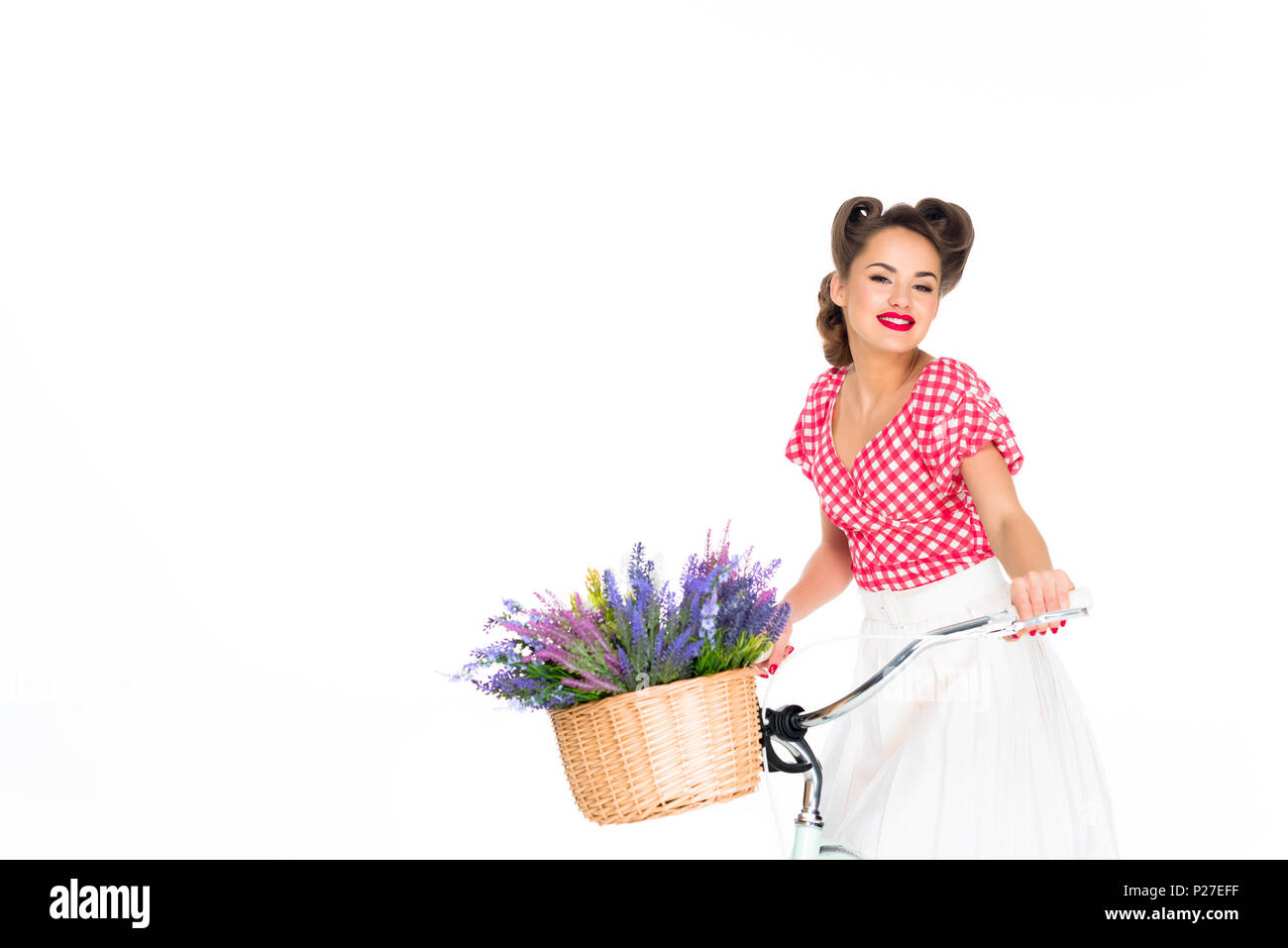 attractive pin up woman on bicycle with basket of flowers isolated on