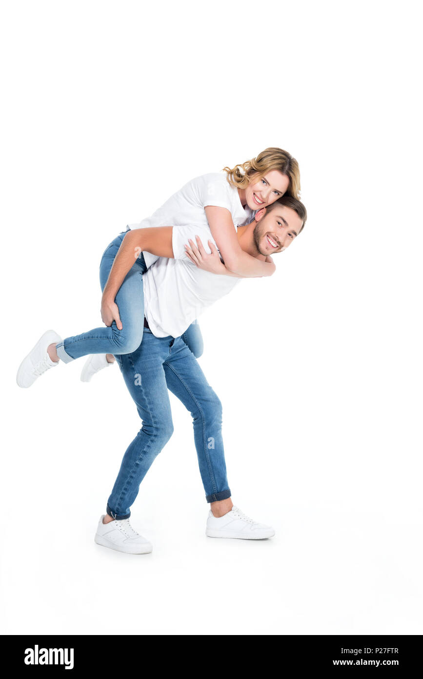 handsome man piggybacking his smiling girlfriend, isolated on white Stock Photo