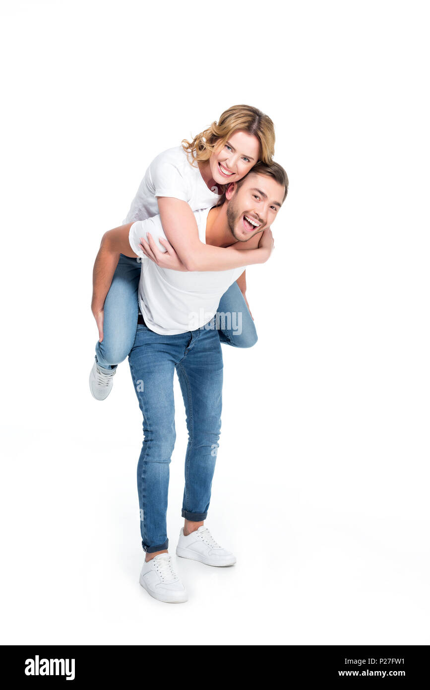 excited man piggybacking his girlfriend, isolated on white Stock Photo