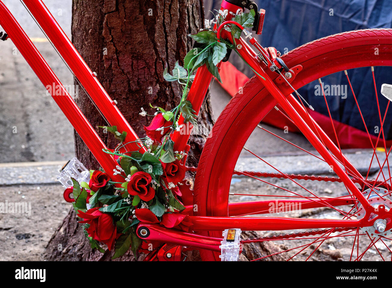 New York City, Soho, Manhattan.  Close Up View of a flower decorated red delivery bicycle, parked on a Soho, Manhattan, NYC, Street. Stock Photo