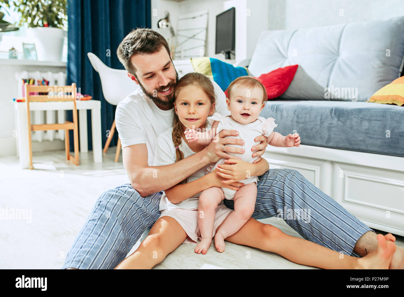 Baby with fathers long legs Stock Photo - Alamy