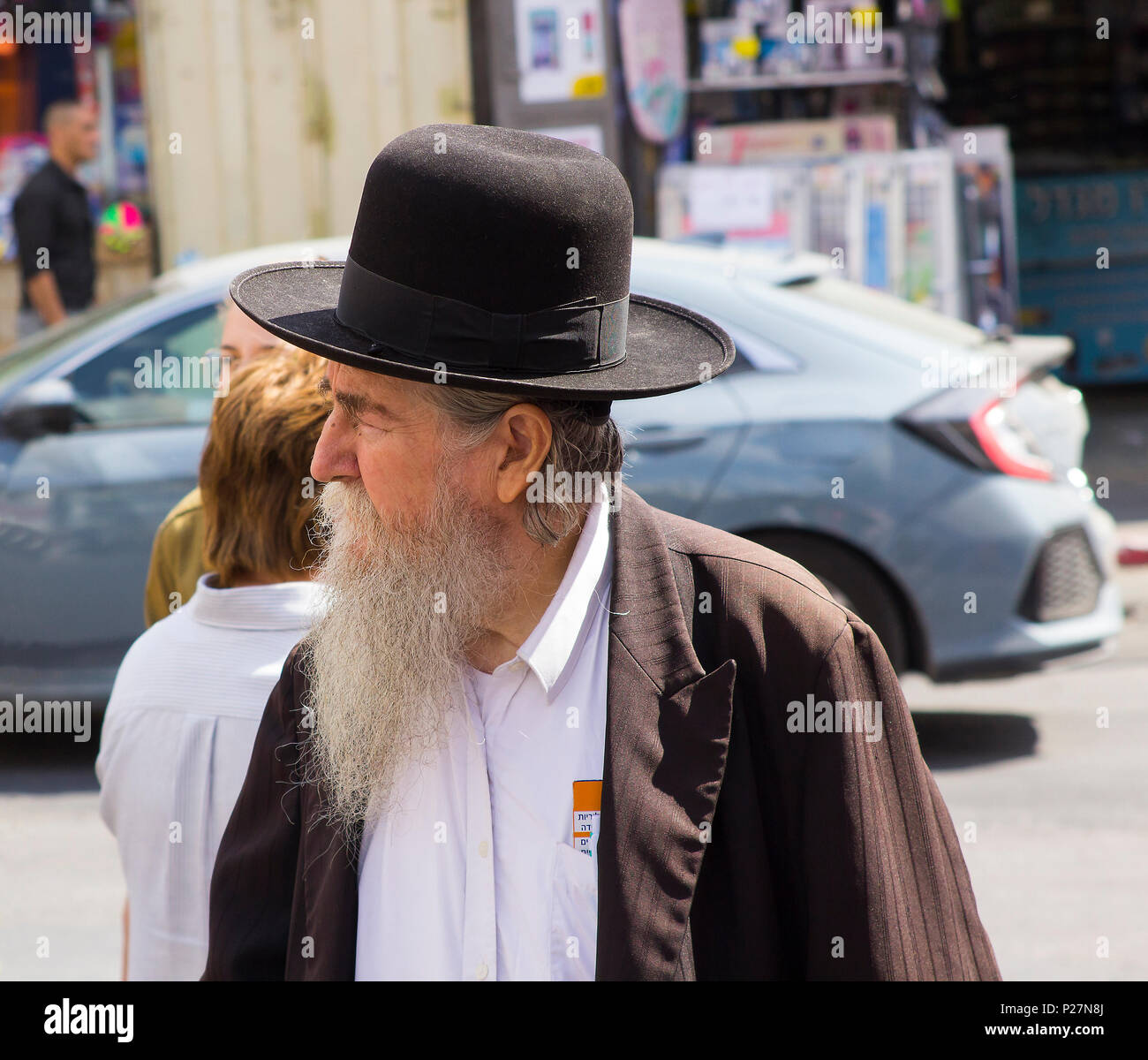 9 May 2018 An aged Hasidic Jew with a long white beard in traditional clothing on foot in a busy street in Jerusalem Israel Stock Photo
