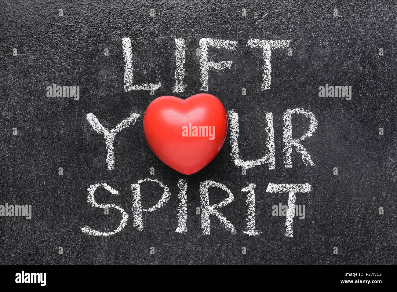 lift you spirit phrase handwritten on blackboard with heart symbol instead of O Stock Photo