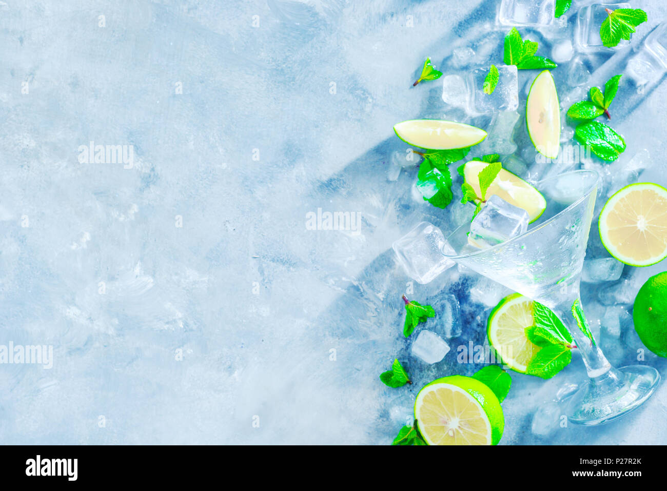 Mint, lime and ice cubes, mojito cocktail ingredients header with copy space. Making summer drinks close-up. Sunlight and refreshment concept. Stock Photo