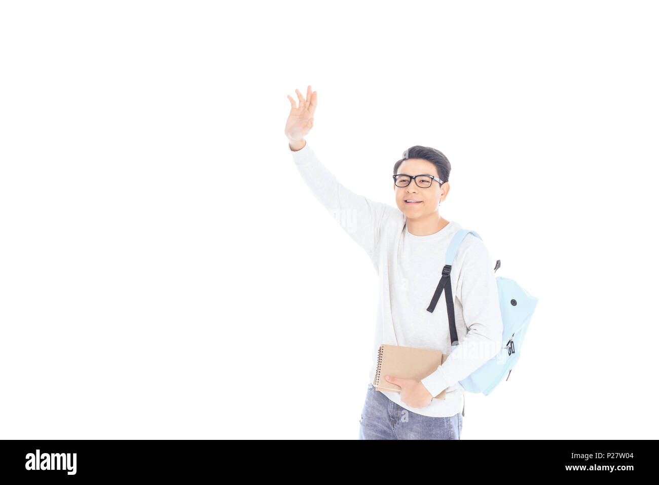 portrait of asian student with backpack and notebooks waving to someone isolated on white Stock Photo