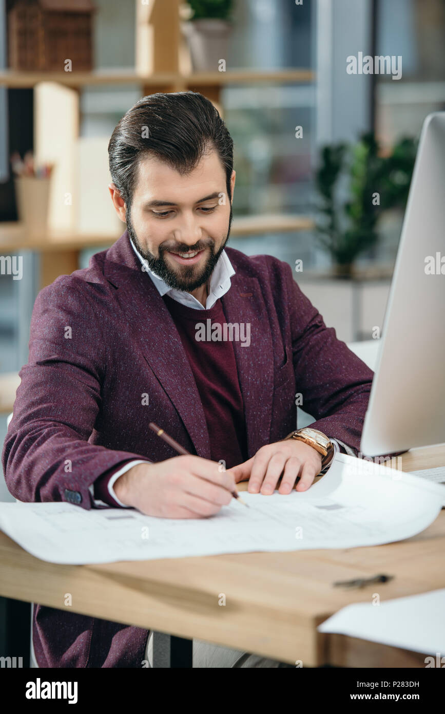 architect drawing blueprint at workplace with computer Stock Photo Alamy