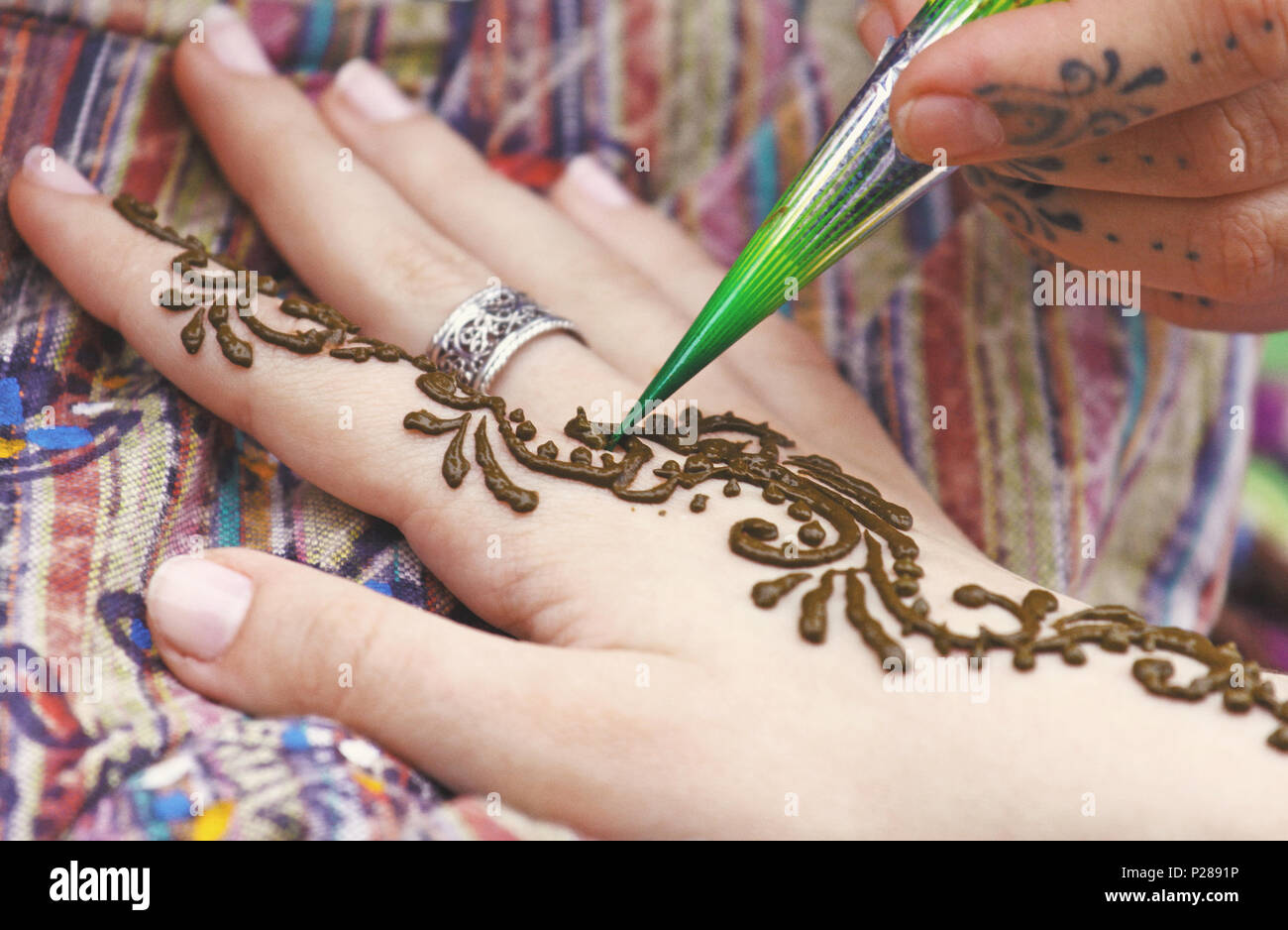 Artist painting traditional indian henna tattoo on woman hand, closeup picture, focus on mehndi artwork Stock Photo - Alamy Artist painting traditional indian henna tattoo on woman hand, closeup picture, focus on mehndi artwork Stock Photo - Alamy
