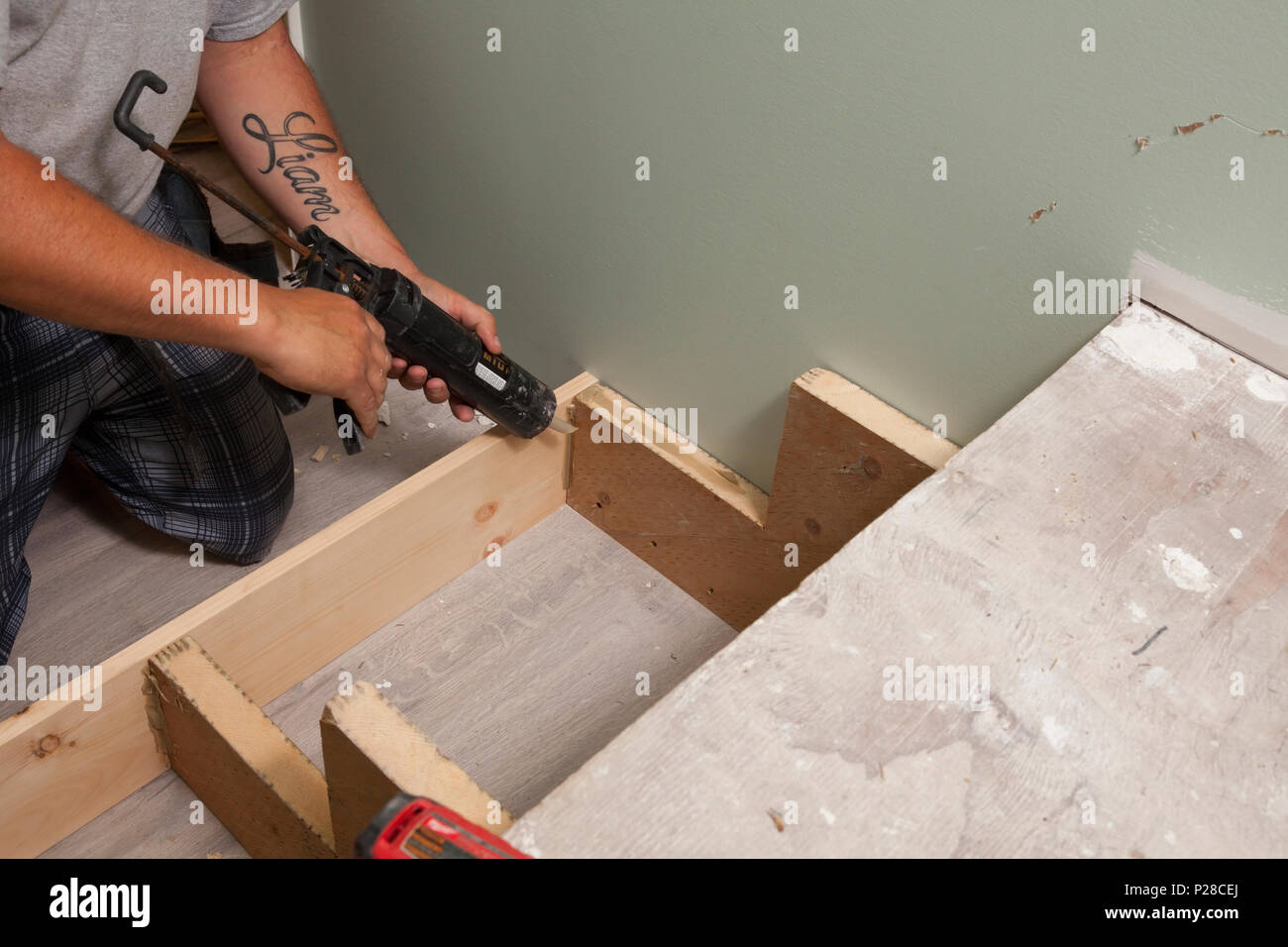 A construction worker using a caulking gun. Stock Photo