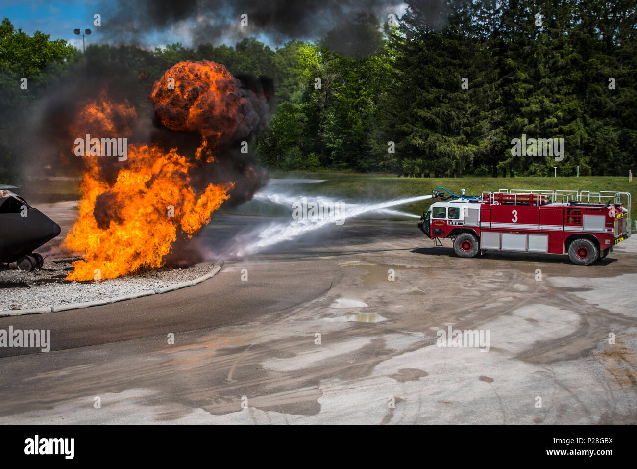 Airmen from the 179th Airlift Wing Fire Department, Mansfield, Ohio, conduct aircraft crash recovery training, June 4, 2018, held at the Alpena Combat Readiness Traning Center, Alpena, Michigan. Airmen use fire trucks to circle the simulated aircraft crash site and extinguish the flames created by a controlled propane live fire system. The training is focused on full spectrum readiness preparing the wing to respond to local, state or federal activations at a moments notice. (U.S. Air National Guard photo by Capt. Paul Stennett/Released) Stock Photo