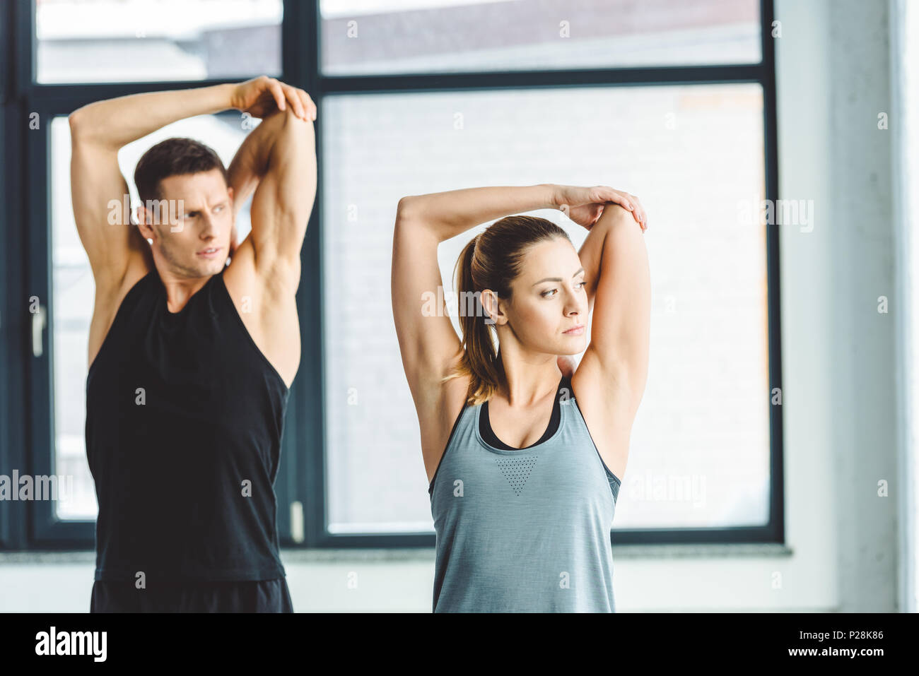 Young athletes stretching before workout hi-res stock photography and ...
