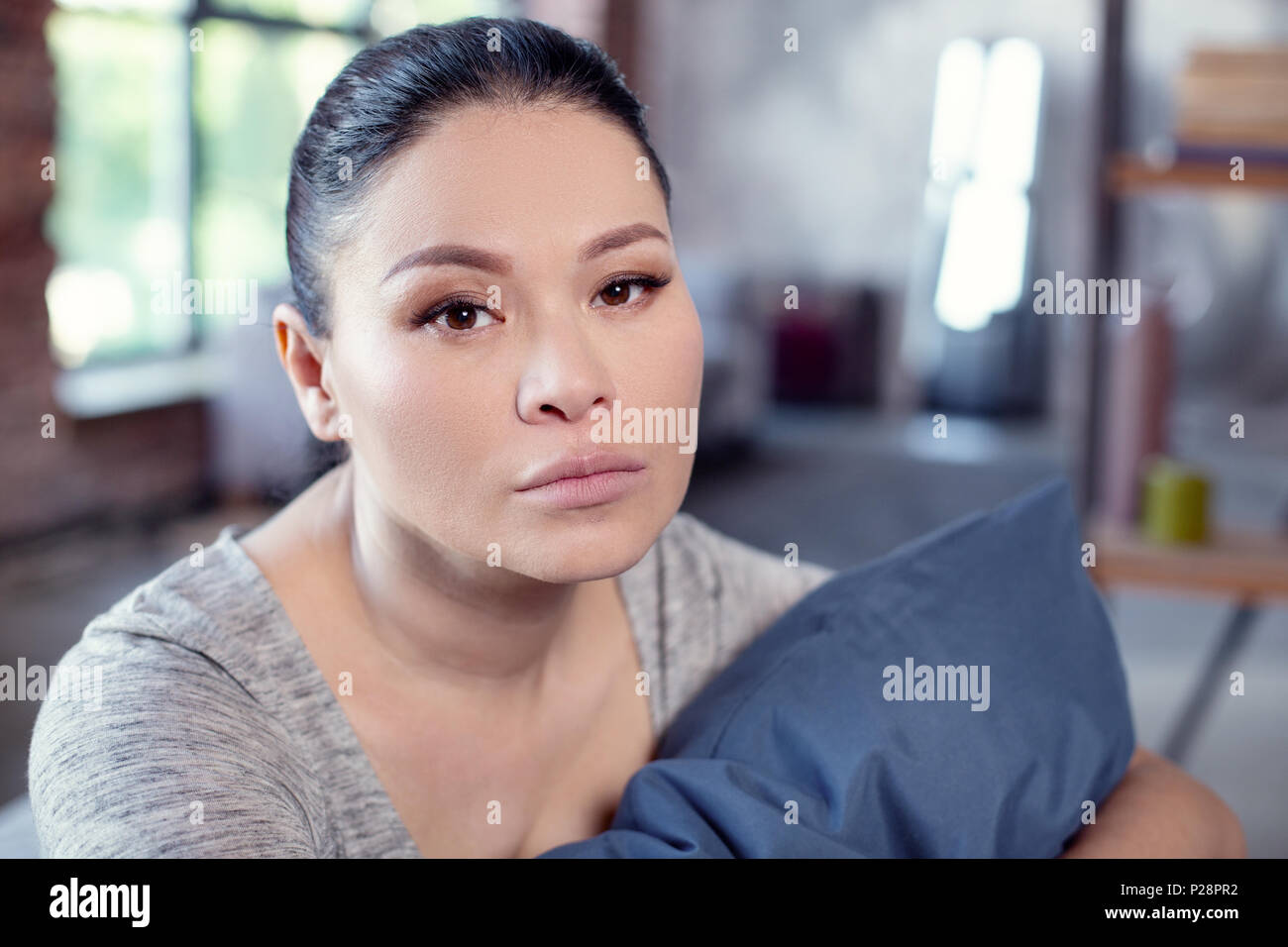 Fatigued upset woman confronting sleep disorder Stock Photo
