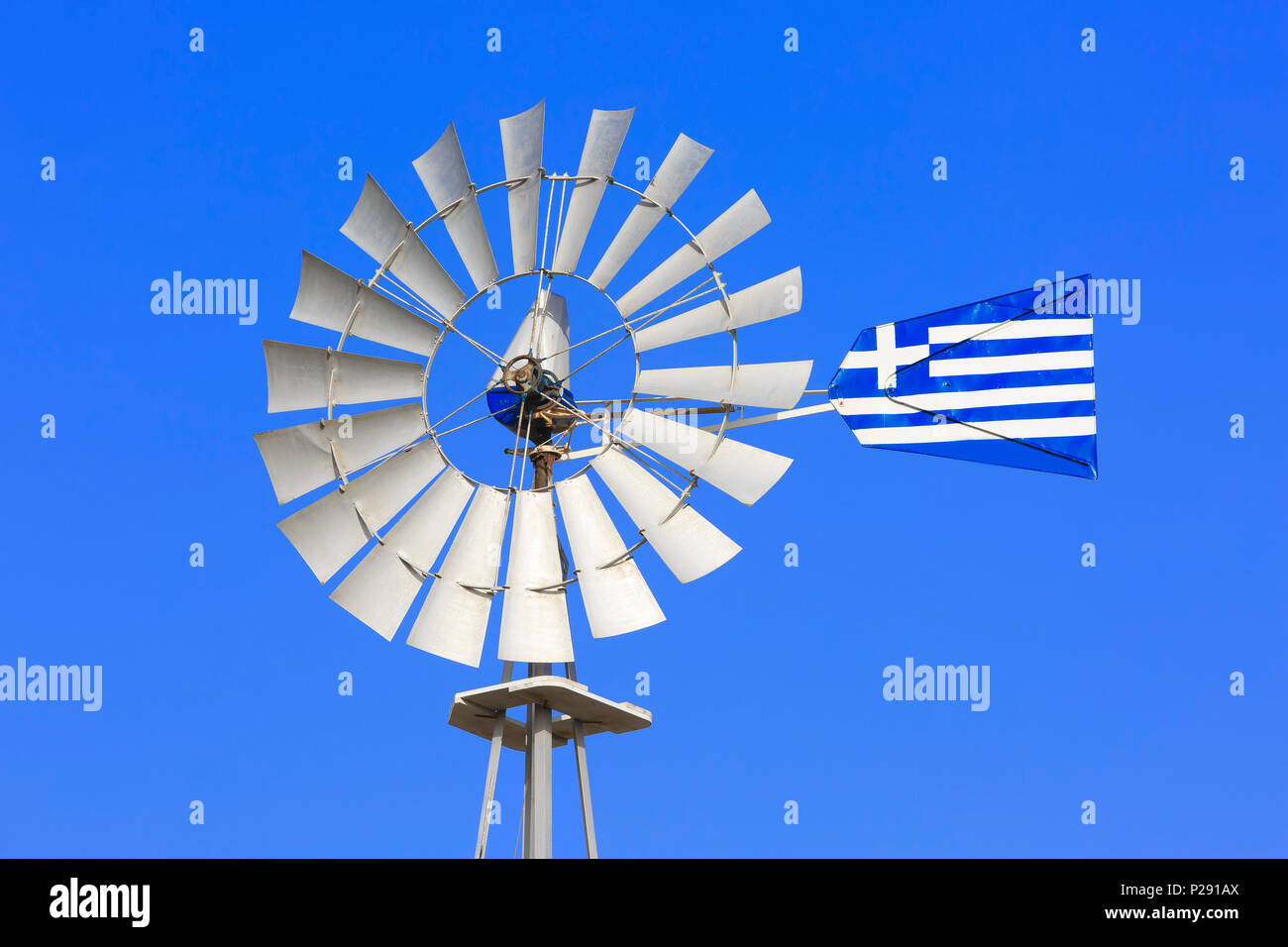 A windpump (type of windmill) with the Greek flag in Protaras, Cyprus Stock Photo
