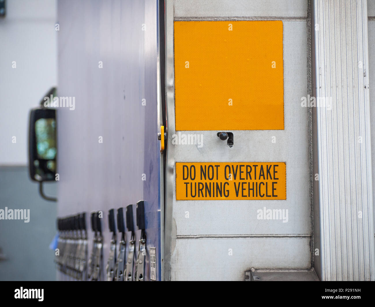 Warning sign of Do not overtake turning vehicle attached to the rear of a truck. Melbourne, VIC Australia Stock Photo