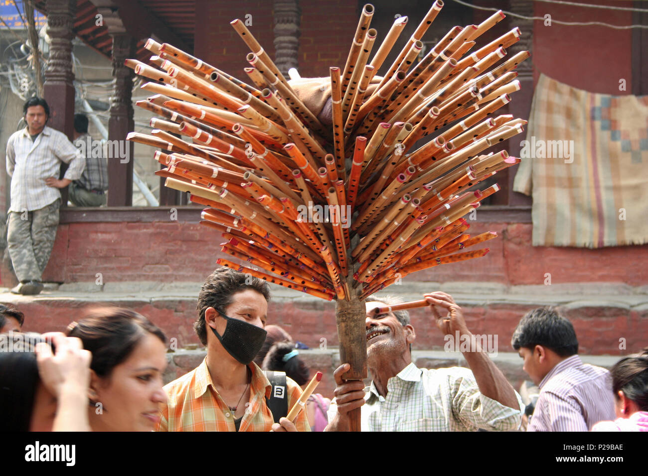 Fluid salesman at work on Durbar Square, Kathmandu Stock Photo