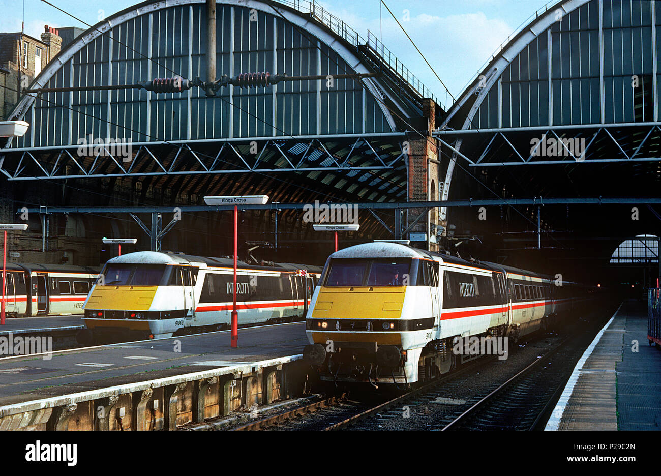 A pair of class 91 electric locomotives in the original Swallow InterCity livery numbers 91009 (left) and 91010 (right) await their next turns of duty at London Kings Cross. 14th August 1992. Stock Photo