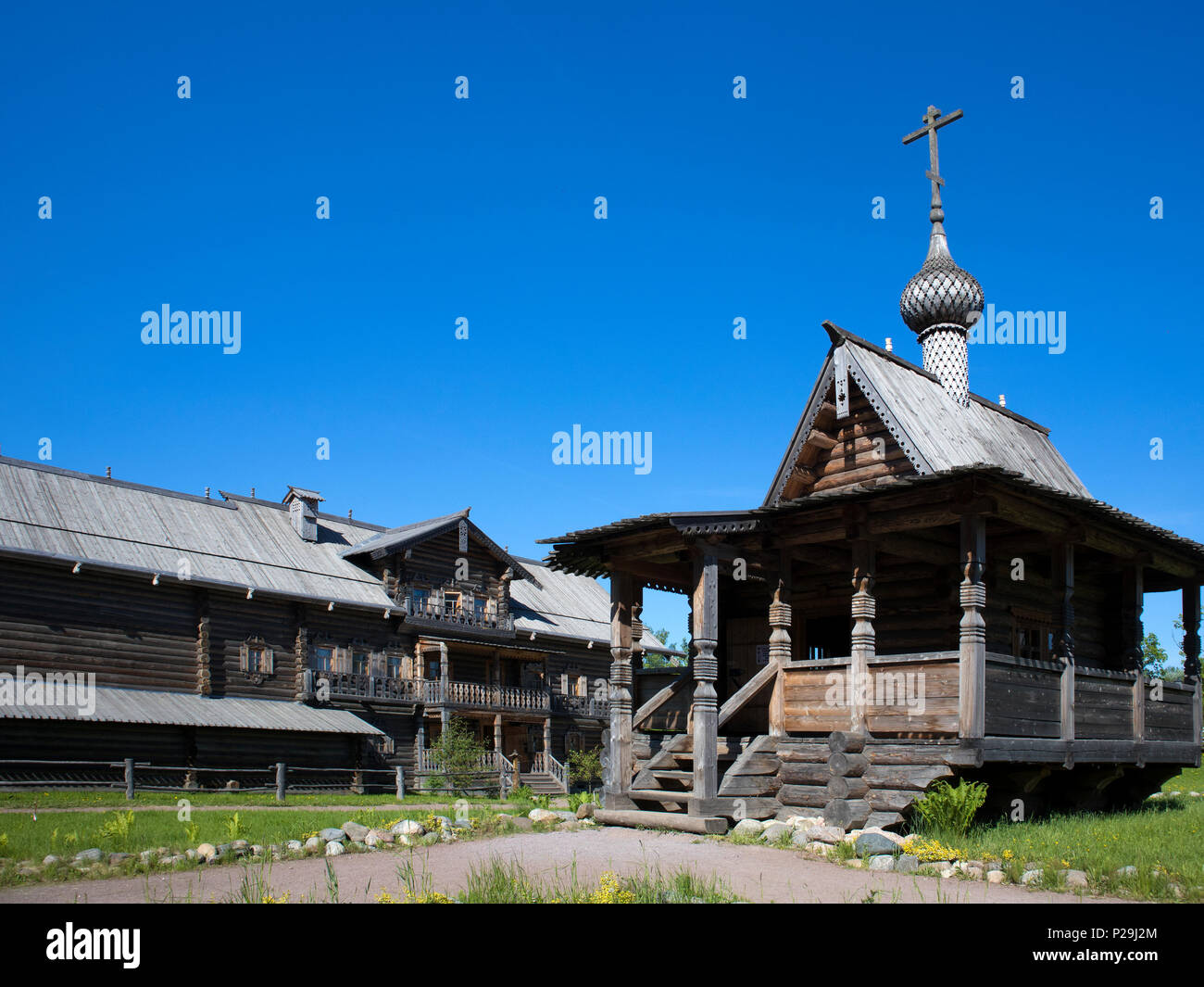 Old russian wooden architecture, small wooden church against blue sky Stock Photo