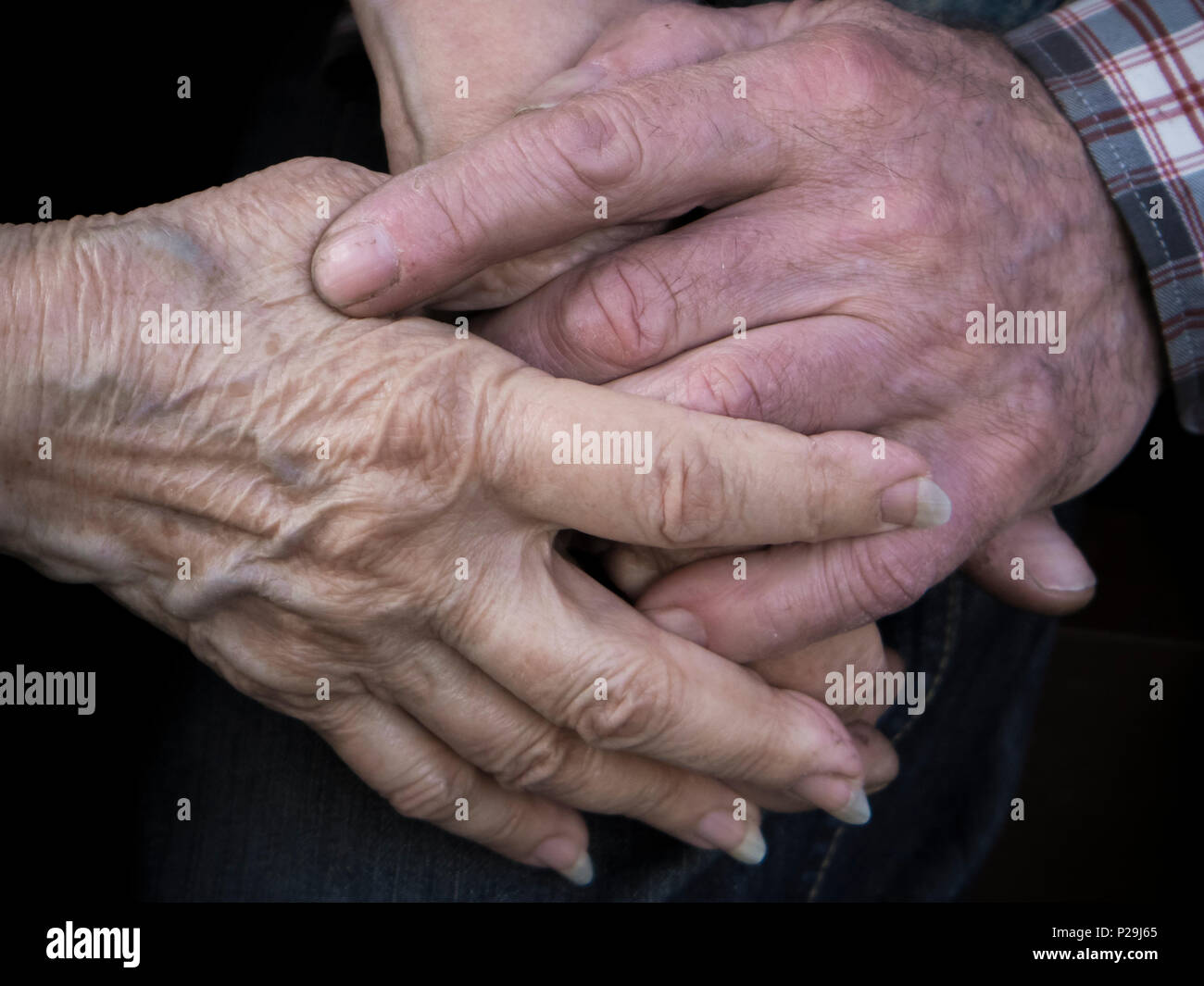 Elderly couple holding hands, expression of love and tenderness, close up Stock Photo