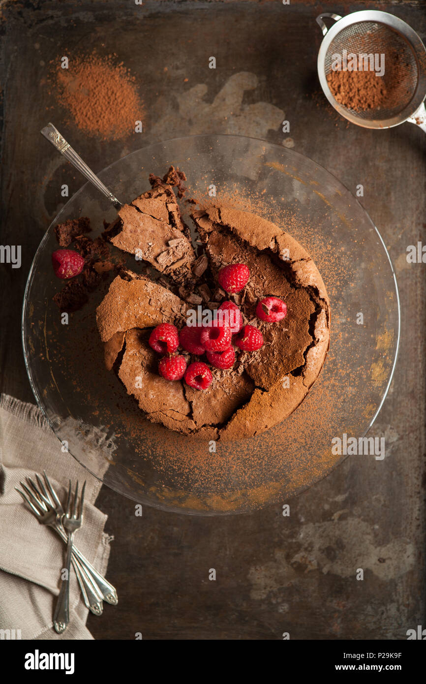Rich chocolate torte with chocolate flakes and raspberries Stock Photo