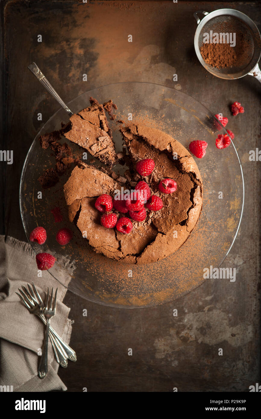 Rich chocolate torte with chocolate flakes and raspberries Stock Photo