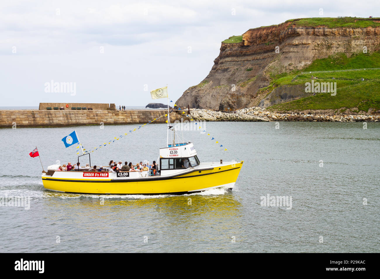A small tourist boat returning to Whitby Harbour Stock Photo - Alamy