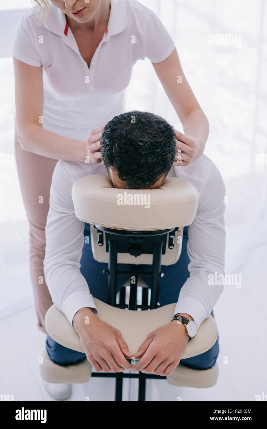 Masseuse Doing Seated Shoulder Massage For Businessman Stock Photo, Picture  and Royalty Free Image. Image 114325390.