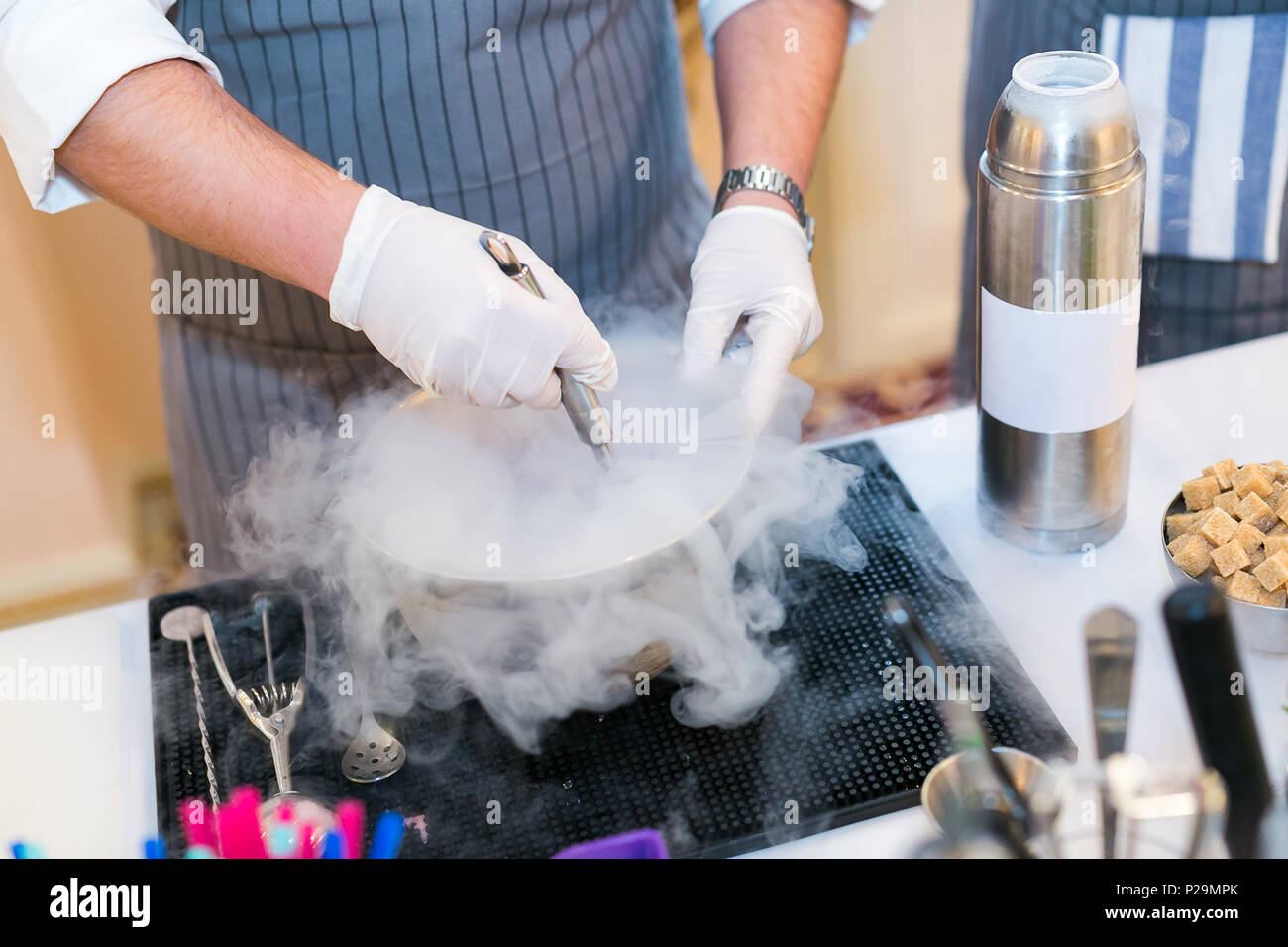 barman cooks molecular cocktail with use of liquid nitrogen. alcoholic molecular beverages for a party. Stock Photo