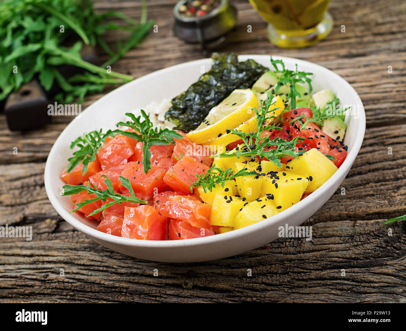 Hawaiian salmon fish poke bowl with rice, avocado, mango, tomato ...