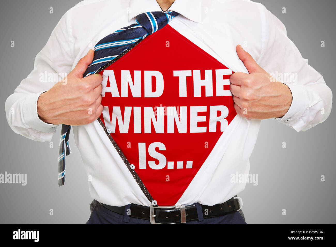 Man reveals slogan 'And the winner is' on t-shirt underneath his business shirt Stock Photo