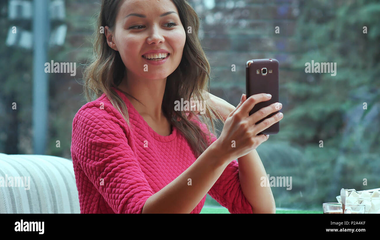 Young woman taking a selfie in coffee shop Stock Photo - Alamy