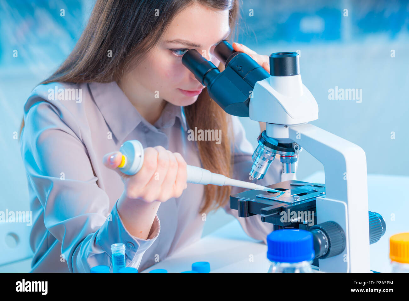 Lab Assistant Imags laboratory assistant with a pipette and a microscope in the laboratory ...