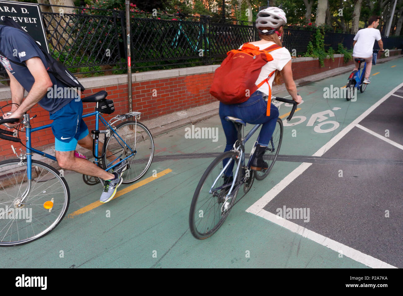 Bicyclists on a bicycle lane on Chrystie St,  and E. Houston St. in New York, NY. Stock Photo