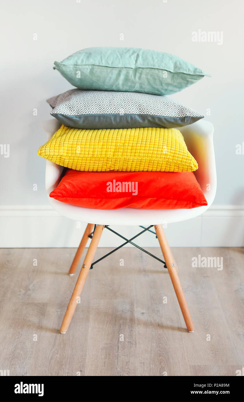 Chair in an interior with pillows in trendy colors. Concept of cozy and trendy interior Stock Photo