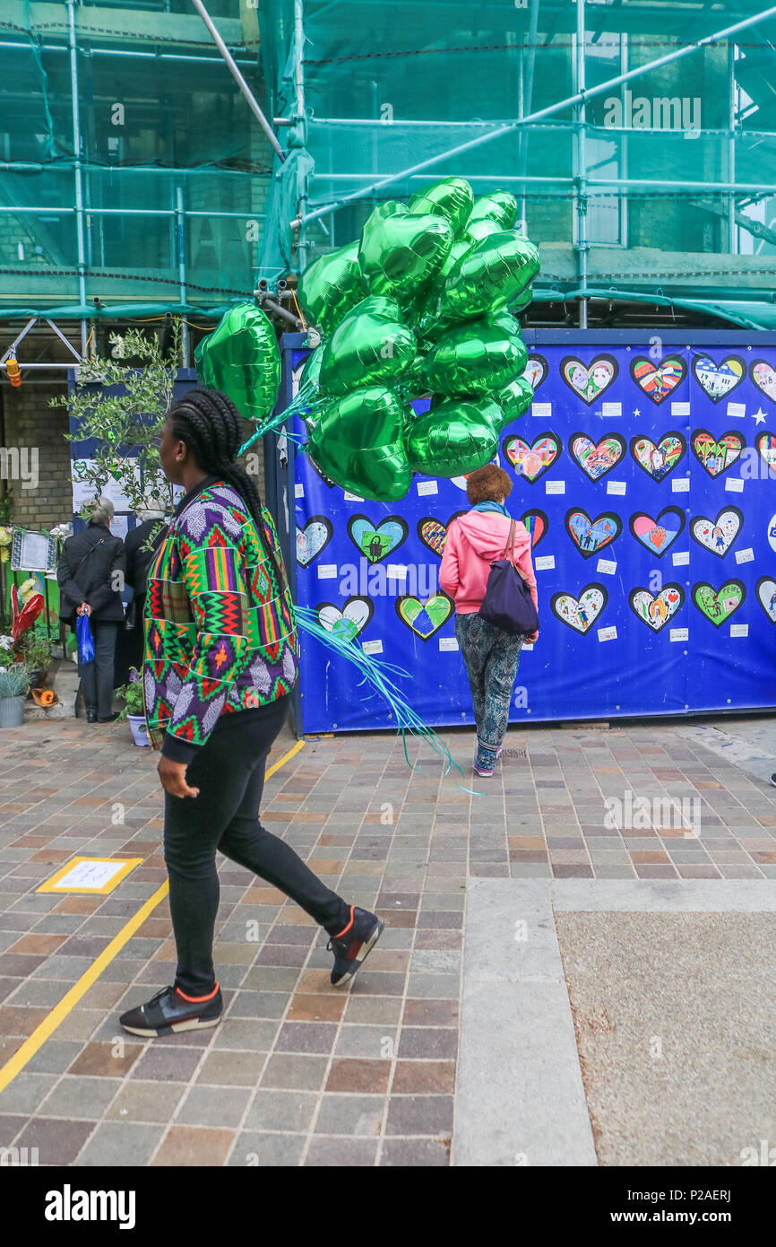 London UK. 14th June 2018. Green ballons to mark the Grenfell anniversary a year after the fire  in West London which claimed the lives of 72 residents in the tower block.  A minute's silence will be observed nationally at midday to remember the victims of the Grenfell fire on 14 June 2017. Credit: amer ghazzal/Alamy Live News Stock Photo