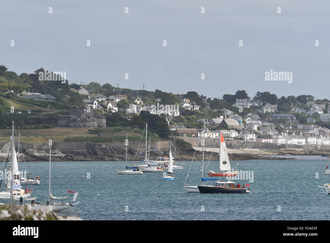 Falmouth, Cornwall, UK. 14th June 2018. Competitors line up for the start  of the SITraN Challenge Race to Les Sables d’Olonne, France, from where the Golden Globe race will start. The race was started by a Sir Robin Knox Johnstone from his boat Sulhaili, after a week of celibrations in Falmouth. Seen here from Pendennis point looking towards St Mawes Credit: Simon Maycock/Alamy Live News Stock Photo
