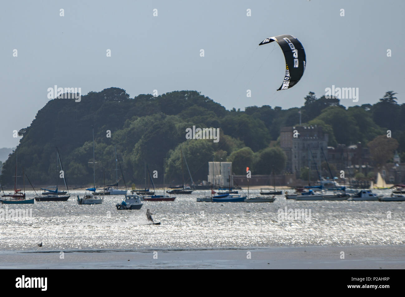 Poole, UK. 14th June, 2018. Kite surfers make the most of the windy weather in Poole Harbour. Credit Thomas Faull/Alamy Live News. Stock Photo