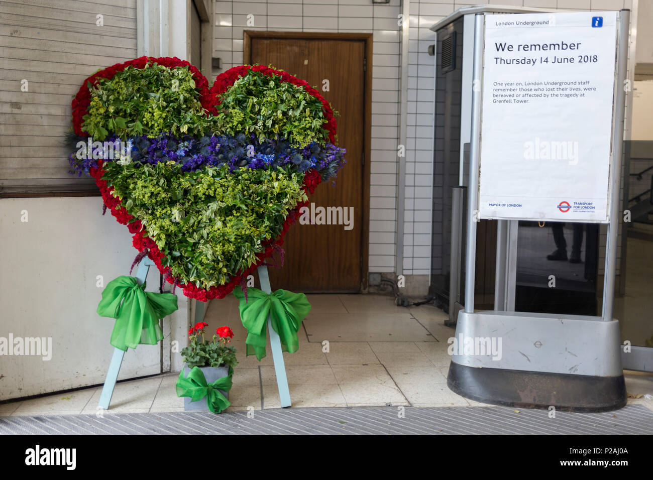 London, UK. 14th Jun, 2018.  A memorial wreath at the entrance of Latimer Road tube station on the first anniversary of the Grenfell tower fire. 72 people died when the tower block in the borough of Kensington & Chelsea were killed in what has been called the largest fire since WW2. The 24-storey Grenfell Tower block of public housing flats in North Kensington, West London, United Kingdom. It caused 72 deaths, out of the 293 people in the building, including 2 who escaped and died in hospital. Over 70 were injured and left traumatised. Credit: RichardBaker/Alamy Live News Stock Photo