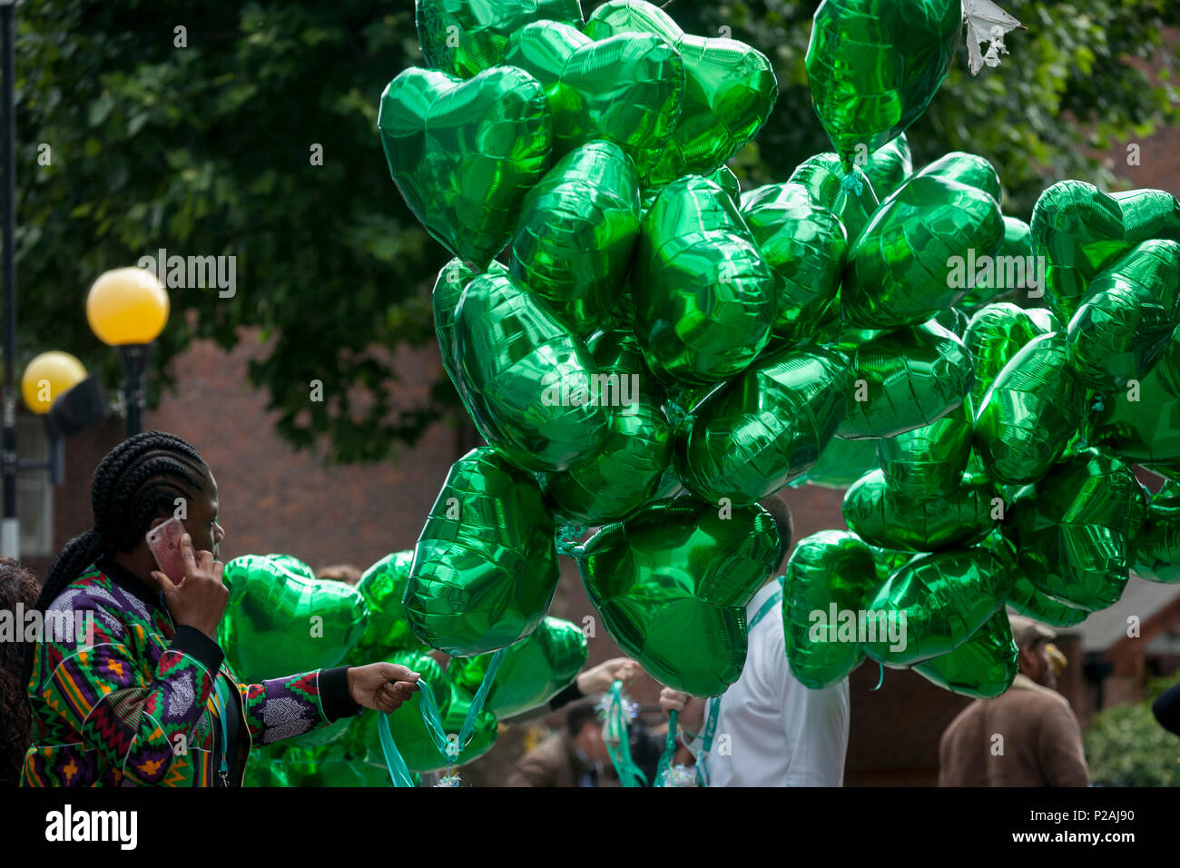 London, UK. 14th Jun, 2018.  Green heart-shaped balloons during the memorial service for the Grenfell fire on the first anniversary of the tower block disaster. 72 people died when the tower block in the borough of Kensington & Chelsea were killed in what has been called the largest fire since WW2. The 24-storey Grenfell Tower block of public housing flats in North Kensington, West London, United Kingdom. It caused 72 deaths, out of the 293 people in the building, including 2 who escaped and died in hospital. Over 70 were injured and left traumatised. Credit: RichardBaker/Alamy Live News Stock Photo