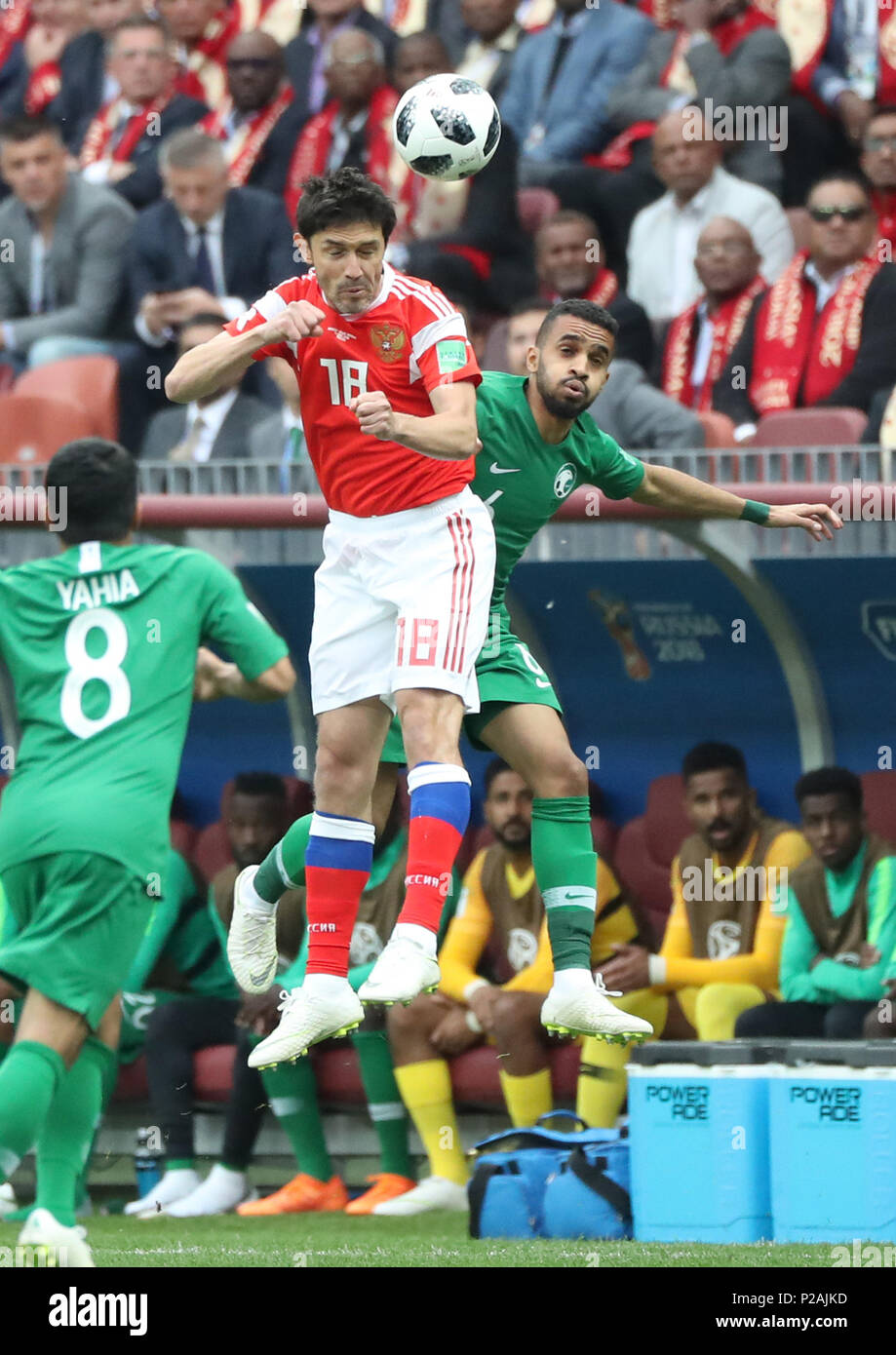 Moscow, Russia. 14th June, 2018. Russia's Yury Zhirkov (top) vies with Saudi Arabia's Mohammed Alburayk during the opening match of the 2018 FIFA World Cup in Moscow, Russia, on June 14, 2018. Credit: Xu Zijian/Xinhua/Alamy Live News Stock Photo