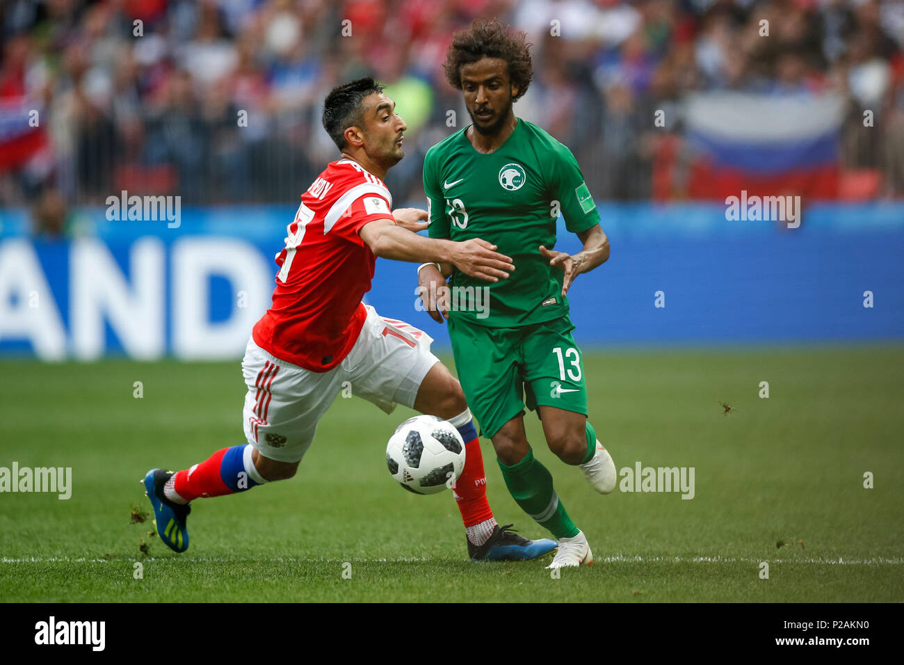 Moscow, Russia. 14th June 2018. Aleksandr Samedov of Russia and Yasser Al-Shahrani of Saudi Arabia during the 2018 FIFA World Cup Group A match between Russia and Saudi Arabia at Luzhniki Stadium on June 14th 2018 in Moscow, Russia. Credit: PHC Images/Alamy Live News Stock Photo