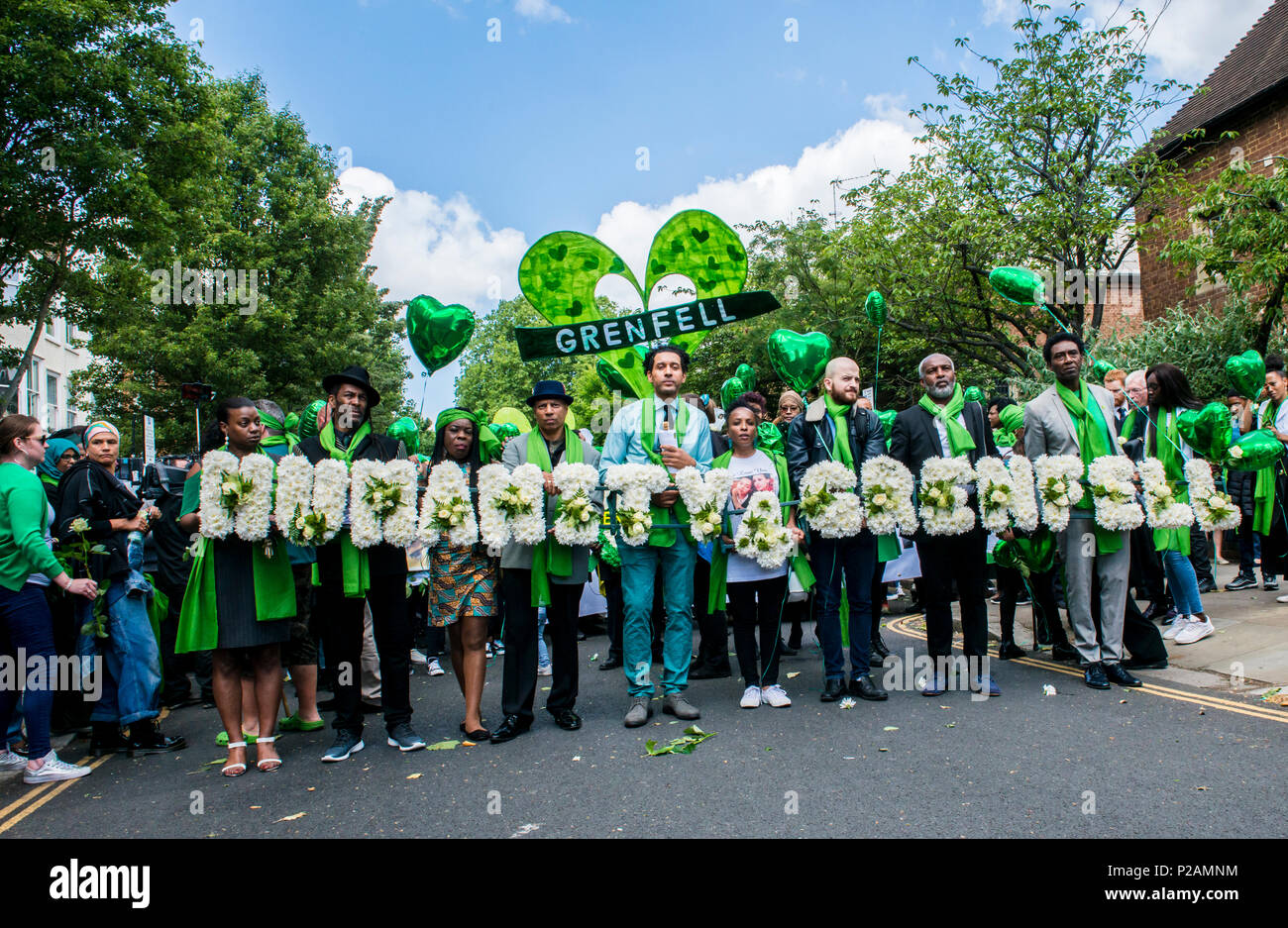 Friends and family members walk towards Grenfell Tower, to mark the one year anniversary of the fire, London, England, UK, 14th June 2018 Stock Photo